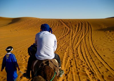 Camel driver leading the way on a private guided Sahara Desert trek with Experience Morocco